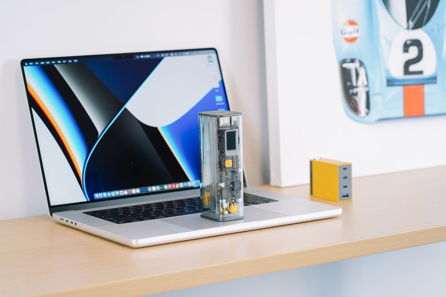 SHARGE Shargeek 100 Powerbank next to a laptop on a desk, showcasing its transparent design and fast charging capabilities.