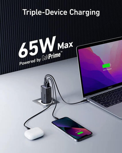 Triple-device charging station with laptop, phone, and mouse on a gray surface with '65W Max' text.