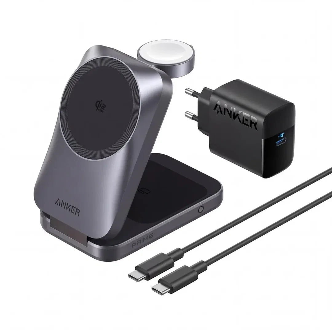 An Anker wireless charging setup on a white background, featuring a gray magnetic wireless charging dock with a circular charging pad, a black USB-C wall charger labeled ANKER, and two black USB-C cables. 45 W. Apple compatible. Qi2.