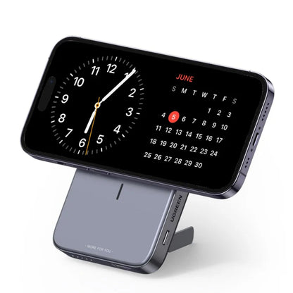 Phone with digital clock and calendar display on a stand with 'Ugreen' branding.